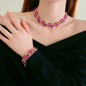 Detail of vintage necklace and bracelet set with purple gems on a female model