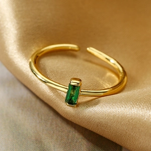 Elegant adjustable gold ring featuring a rectangular emerald green zircon on gold velvet