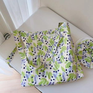 Wrinkled cotton tote bag with nature leaf print and matching hair tie set on white surface