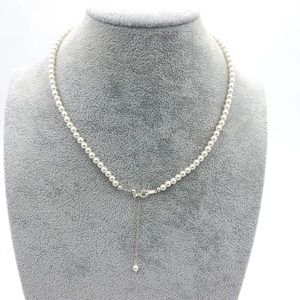Detail of round white pearl necklace with adjustable S925 silver clasp and extension chain