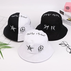 Three embroidered graffiti bucket hats in black and white shown with fashion accessories