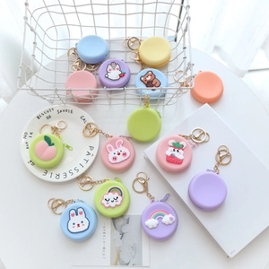 Cute round silicone coin purses in pastel colors with gold keychains and cartoon patterns