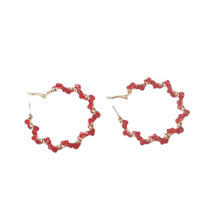 Elegant gold twisted hoop earrings with faceted red crystal beads for women
