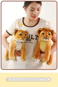 Realistic lion cub and leopard plush toys held by a model in a warm cozy setting