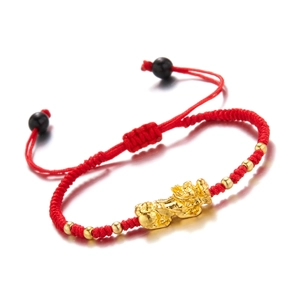 Handmade red braided cord bracelet with a golden Pi Xiu charm and decorative beads