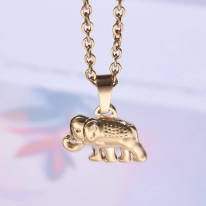 Close-up of golden elephant pendant necklace with textured finish and metal link chain
