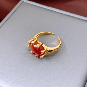 Close-up of vintage 18K gold plated ring with red oval stone and lava texture