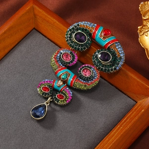 Vintage horn brooch with colorful rhinestones, enamel patterns and blue drop pendant