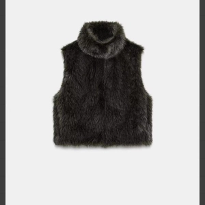 Deep grey faux fur high neck vest featuring a thick, soft texture and sleeveless cut