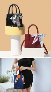 Detail of elegant handbags featuring silk scarves tied on handles for stylish decoration