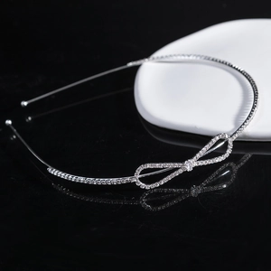 Sparkling rhinestone bow headband in silver finish with elegant minimalist design