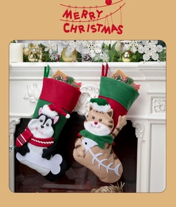 Detailed view of 3D cartoon cat and dog Christmas stockings hanging on a white fireplace