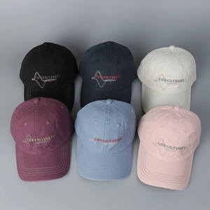 Detailed embroidery of Opportunity lettering on various colors of washed cotton baseball caps