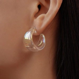 Close-up of thick iridescent acrylic C-shape hoop earring with a modern holographic finish