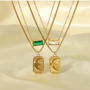 Close-up of double-layer gold necklaces with sun moon pendants and zircons on silk