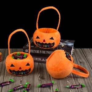 Detailed close-up of three plush pumpkin Halloween baskets with HALLOWEEN embroidery