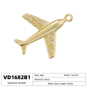 Detailed view of gold airplane pendant with brass material specs and 16mm x 18.5mm size