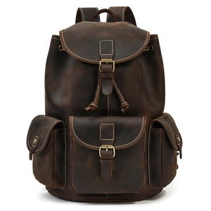 Detailed front view of vintage dark brown leather backpack with multiple buckled pockets