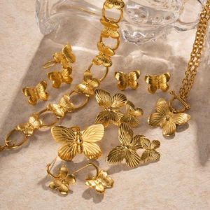 Vintage golden butterfly jewelry set featuring necklace, bracelet, ring and earrings