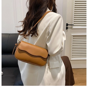 Brown faux leather crossbody bag styled with a white blazer for a minimalist autumn look