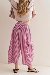 Detail view of pink vertical stripes and elastic high waist on wide-leg trousers