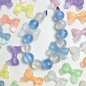Handmade luminous bow beaded phone chain with blue and white iridescent acrylic charms
