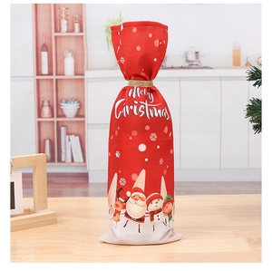 Detail of Christmas wine bottle bag with Santa print and Merry Christmas text decor