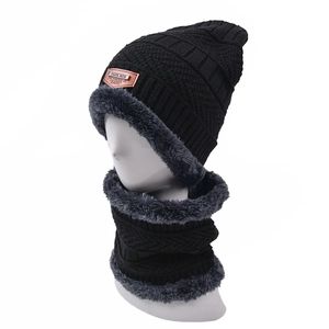 Detail of black knitted hat and neck warmer with thick gray fleece lining on a mannequin
