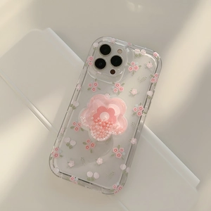 Clear iPhone case with floral print and 3D pink flower kickstand on white surface