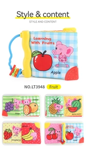 Detail of baby cloth book with colorful fruit patterns and interactive bead handle