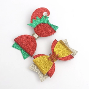 Detailed view of glittering Christmas hair clips in red and green festive colors