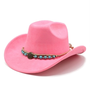 Close-up of pink faux suede cowboy hat featuring tribal turquoise beads and bronze sun pendant