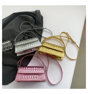 Three metallic croc-embossed mini square bags in silver, gold, and pink mirror finishes