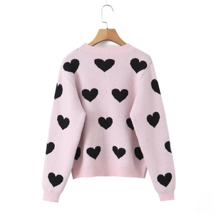 Pink crewneck knit sweater with black heart patterns and ribbed cuffs for women