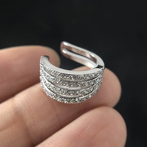 Sparkling four-layer zircon ear cuff in silver finish for non-pierced ears on black background