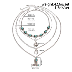 Detailed view of bohemian layered turquoise necklace set with horseshoe and boot charms