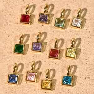 Detail of 12 birthstone charms with colorful square cubic zirconia in 18K gold plating
