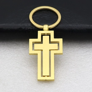 Macro detail of golden double-layer cross keychain with polished metallic texture