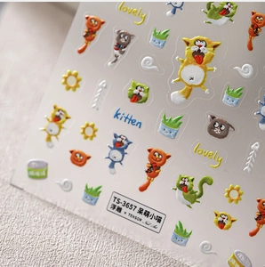 Close-up of 3D embossed cat nail art stickers showing detailed cartoon kitten patterns