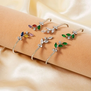 5-piece silver open branch cuffs set with colorful zircon leaves on a pink display