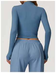 Rear view of tight-fitting blue long-sleeve fitness top with seamless stitching detail