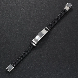 Detail of black braided leather bracelet with polished stainless steel bar plate