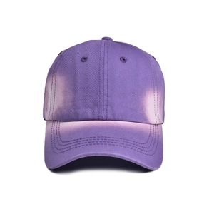 Detail of vintage purple distressed baseball cap with white tie-dye fading and cotton texture
