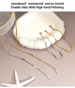 Macro shot of waterproof gold and silver stainless steel necklace set with bar pendants
