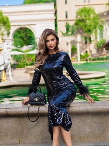 Sparkly black sequin evening dress with ostrich feather sleeves and high slit details