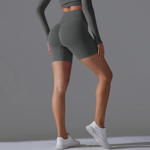 Detail of high-waisted seamless scrunch butt yoga shorts and crop top in dark grey