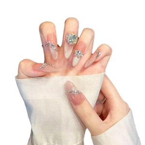 Pink cat eye press-on nails with luxury rhinestones and pearl accents in stiletto shape