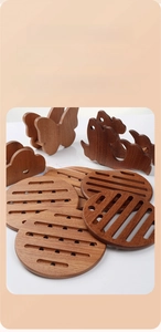 Detailed view of dark brown ebony wood heat insulation pads with decorative stands