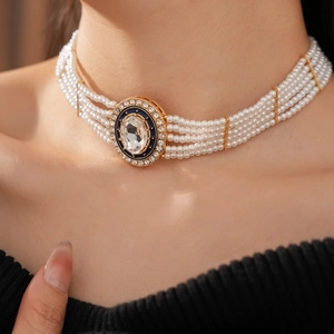 Close-up of luxury multi-layer pearl necklace with a sparkling diamond oval pendant
