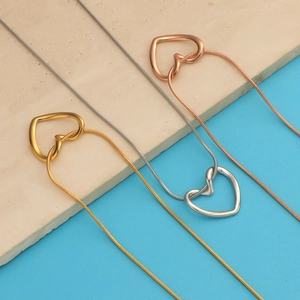Three heart pendant necklaces in gold, silver, and rose gold with sleek snake chains